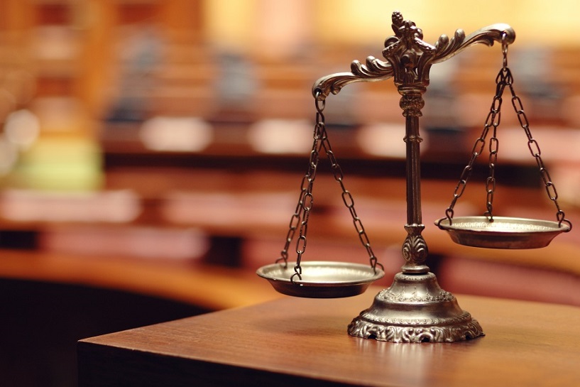 Scales of justice on a courtroom desk