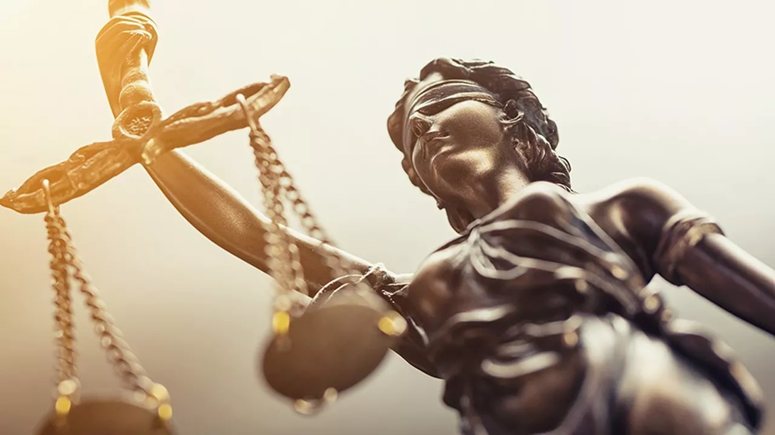 Bronze statue of Lady Justice holding scales