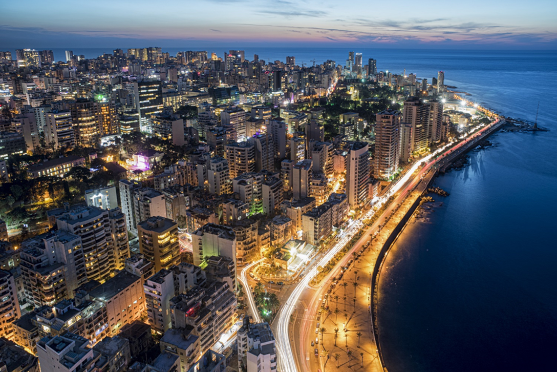 Aerial night view of a coastal city skyline